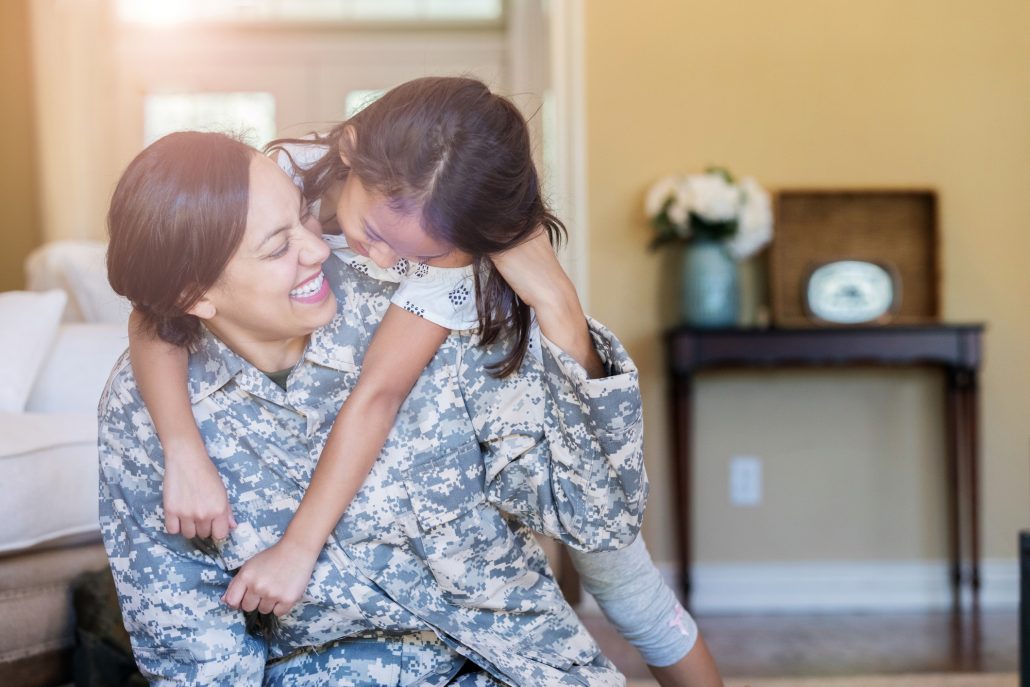 Little girl gives army mom a big hug