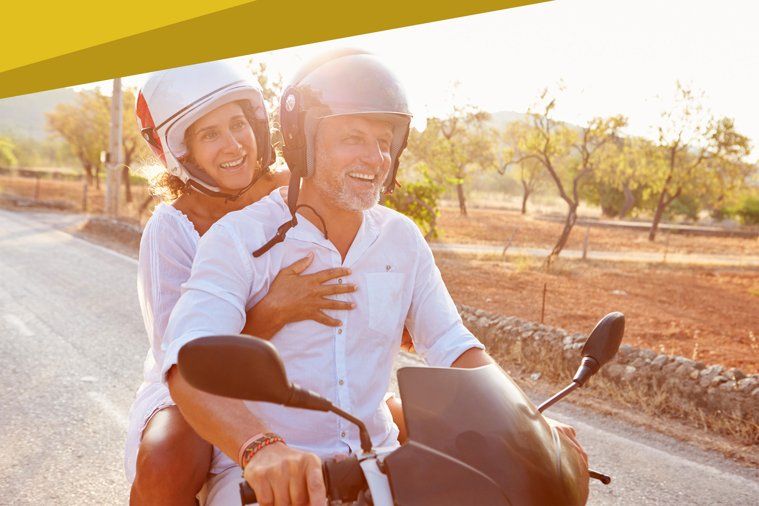 shutterstock_229736884-20200427-about1 Mature Couple Riding Motor Scooter Along Country Road