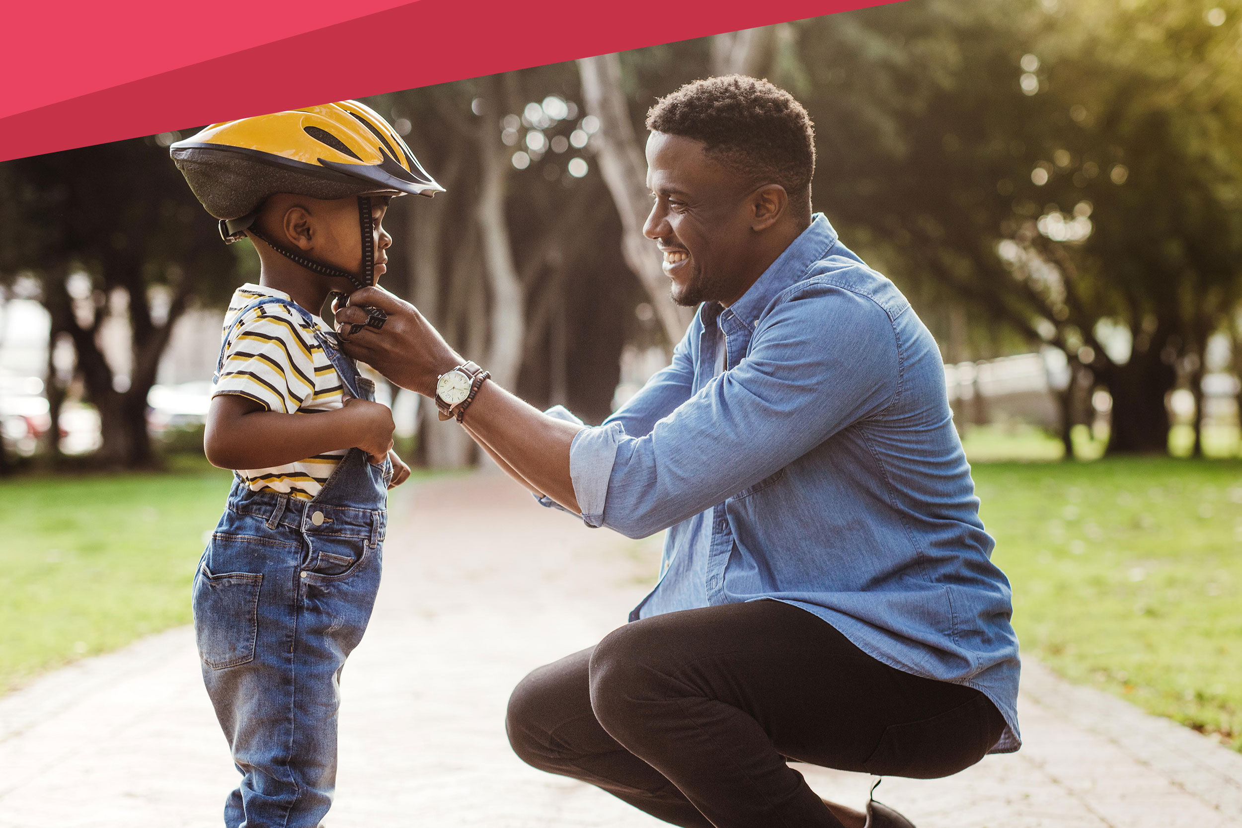 shutterstock_1324489277-20200508-about Father putting helmet on boy at the park. Father puts his son a protective helmet for riding bike.