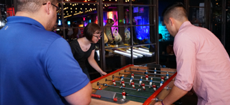 ADP employees in Chelsea playing foosball
