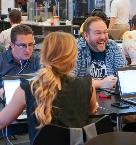 Three ADP employees working on laptops
