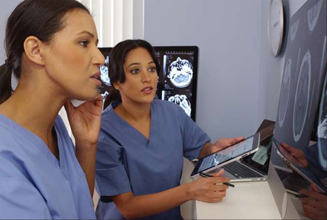 HR_SYS_20_842813_Careersite_storyimages_675X455_1_FINAL-6 Two nurses looking at XRays