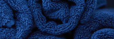 Well-being-Quote-Texture-1 Rolled blue towels