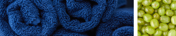 Rolled blue towels. Green grapes