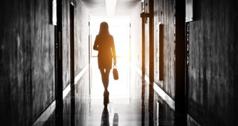 Silhouette of a woman walking down a corridor