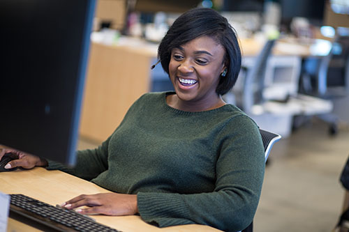 Finance Woman sitting at desk and smiling