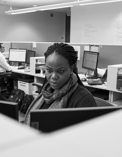 A Reyes Holdings team member working at the computer in workstation.