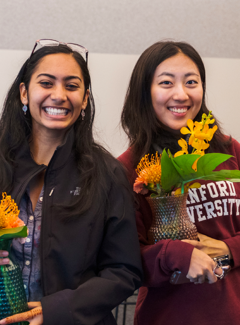 Two women smiling at the camera.