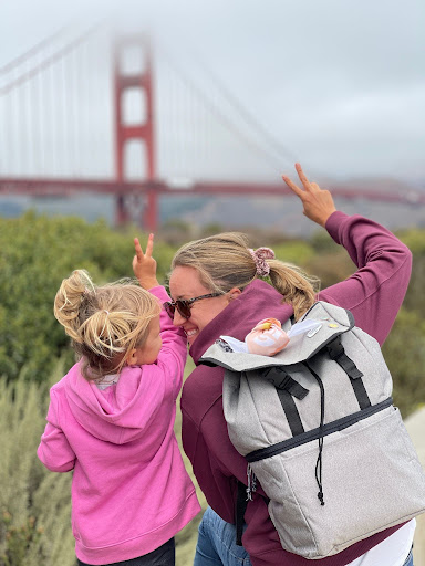 SummerPicnic1 Pinployee Julene and her daughter in front of the Golden Gate Bridge, wearing a Pinterest backpack