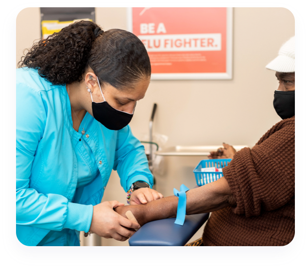 Laboratory professisonal taking blood sample from patient.
