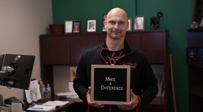 Man holding sign saying Make a Difference