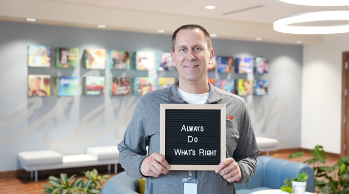 Man holding sign saying Always Do What's Right