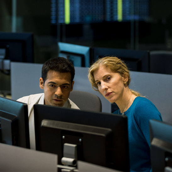 Colleagues looking attentively at computer monitors.