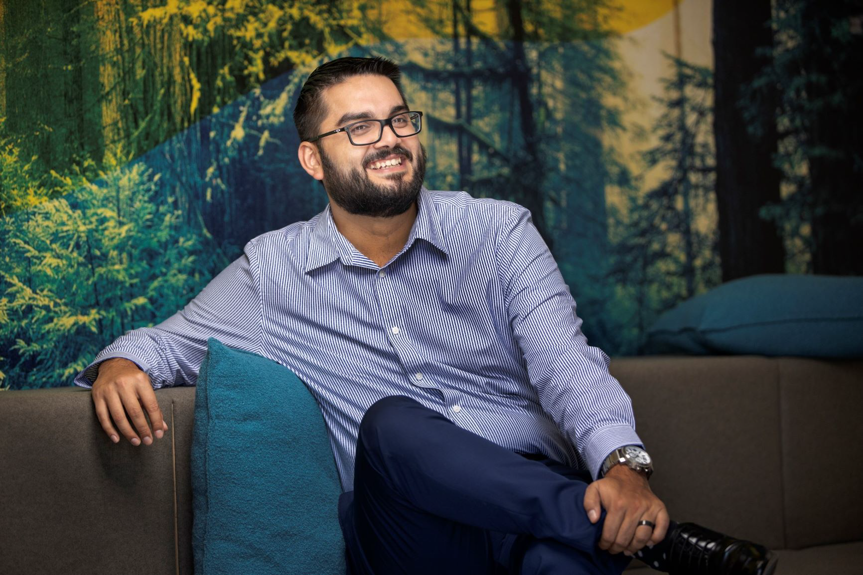 A man sitting on a couch smiling