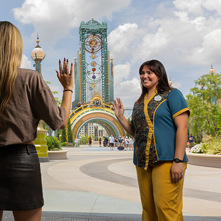 Gallery Epic 1 woman waving to a guest at epic universe