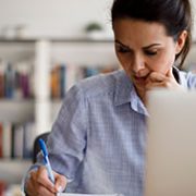 mature woman working on the dining table