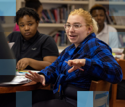 Diverse group of high school students at desks in a classroom setting