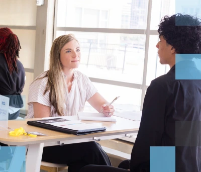 Female corporate recruiter speaking with male high school student