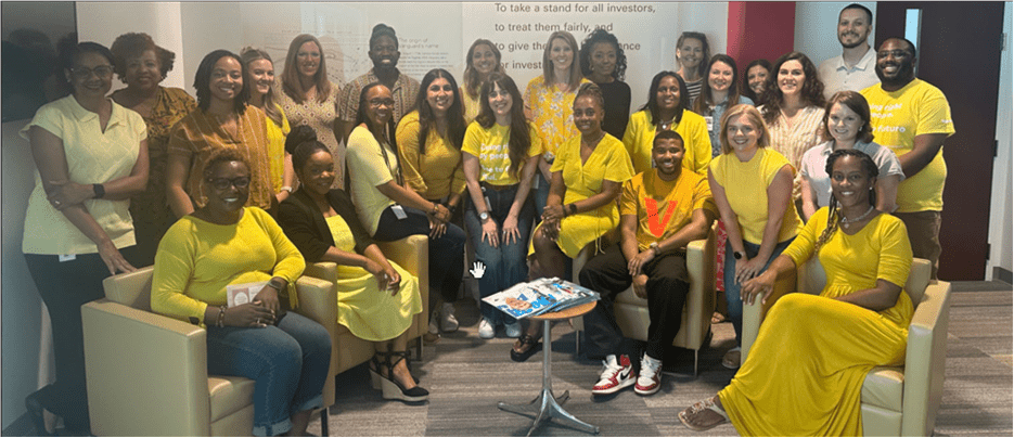 Group photo of Haley along with the HR team, all wearing yellow, posing for a picture at HR Partnership in 2024.