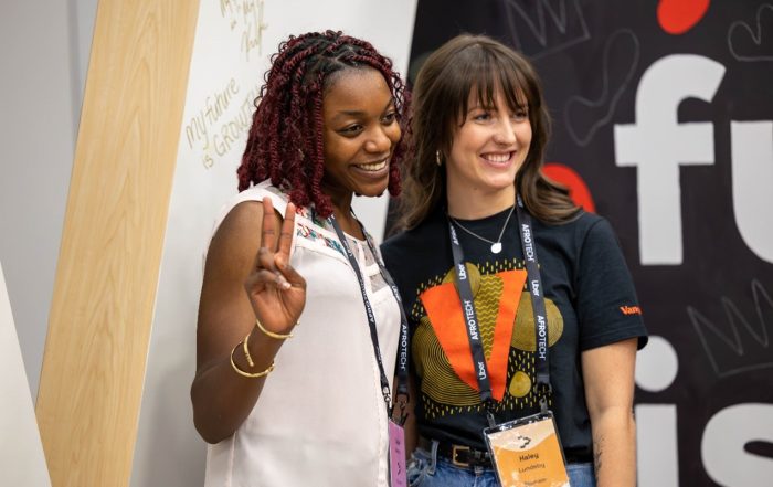 Haley L. smiling and posing with an attendee at the AfroTech conference