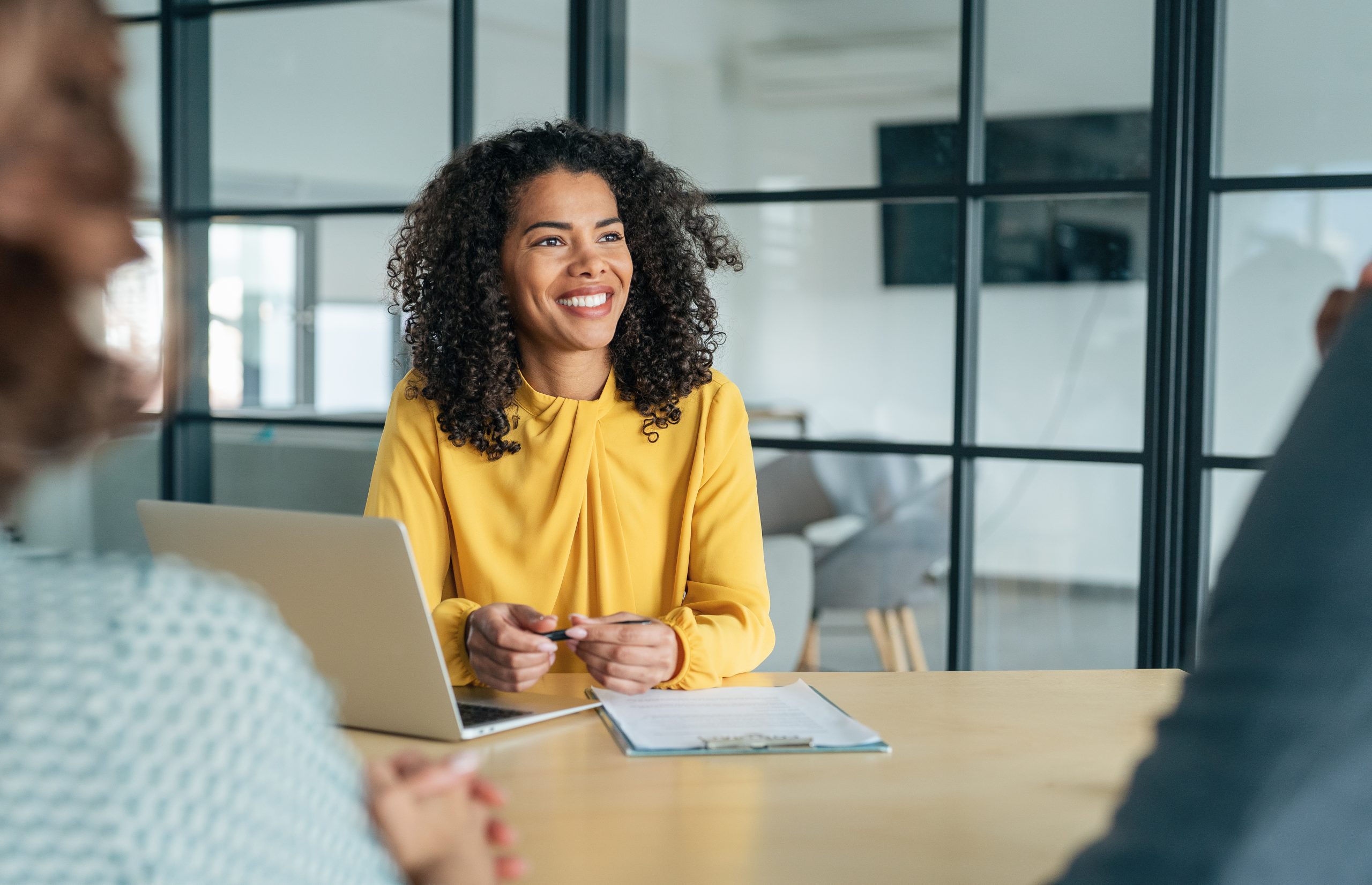 Financial Advisor smiling with clients