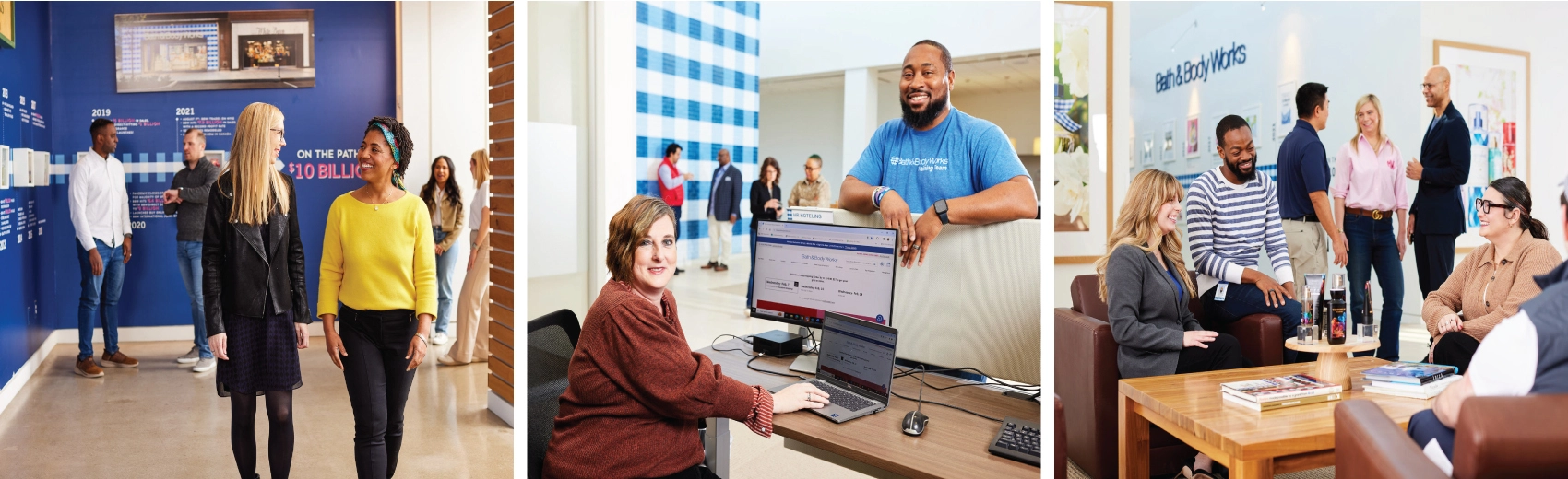 Two Bath & Body Works employees walk inside at the corporate office chatting and smiling. Two Bath & Body Works employees stand talking in a hallway at the corporate office. An employee sits at a desk at the corporate office smiling in front of a blue gingham wall conversing with a smiling colleague. A diverse group of associates sit on comfortable chairs at the corporate office smiling and chatting. Another diverse group of associates stand chatting at a distance.