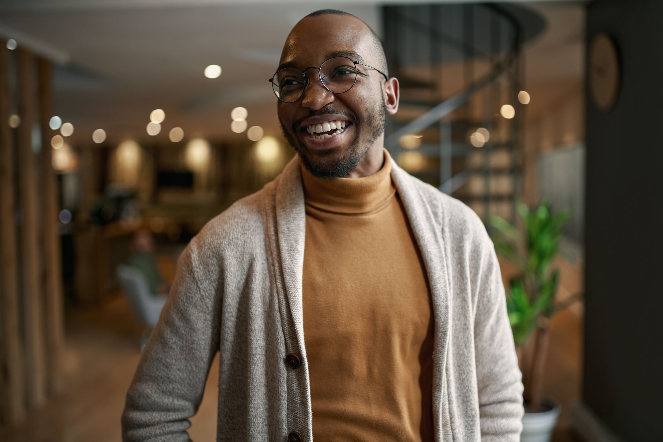 Smiling professional standing confidently, symbolizing Remitly’s analytics team turning data into insights that drive meaningful impact worldwide.