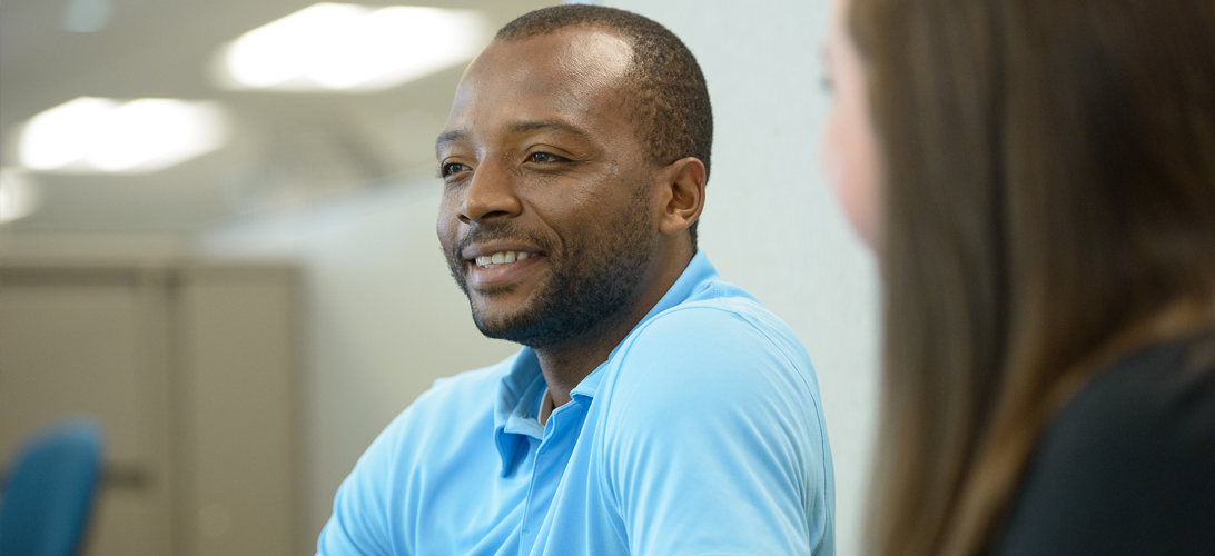 Male Allstate Data Science employee in a meeting with female colleague.