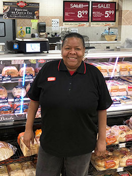 Barbara Powell in front of Deli Dept.