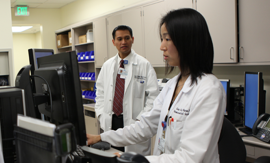 Medical technologist working at a comptuer.