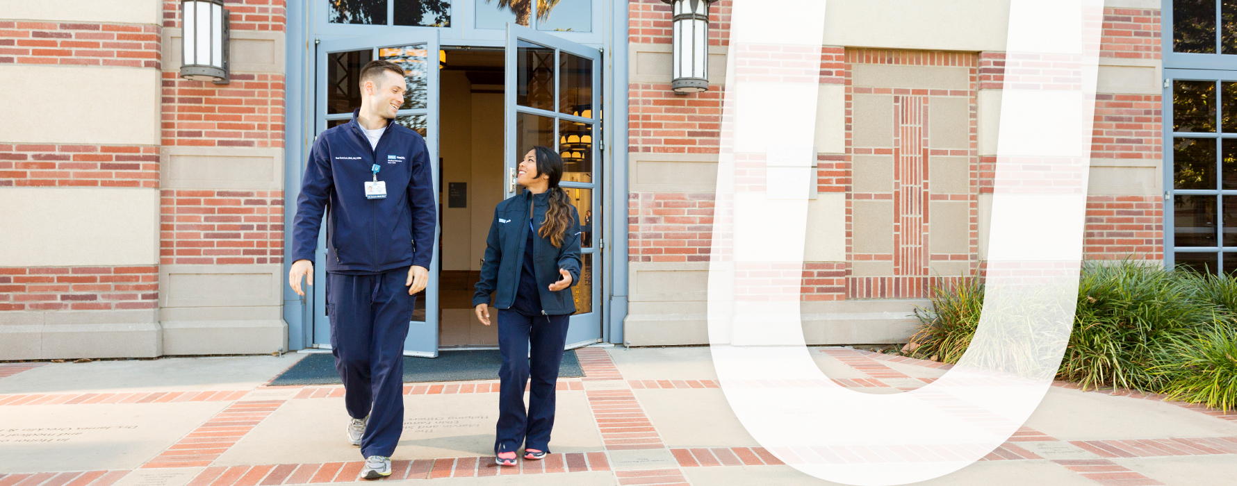 Diverse staff members exiting hospital building
