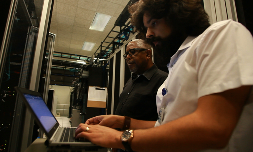 Information technologists working in a server room.