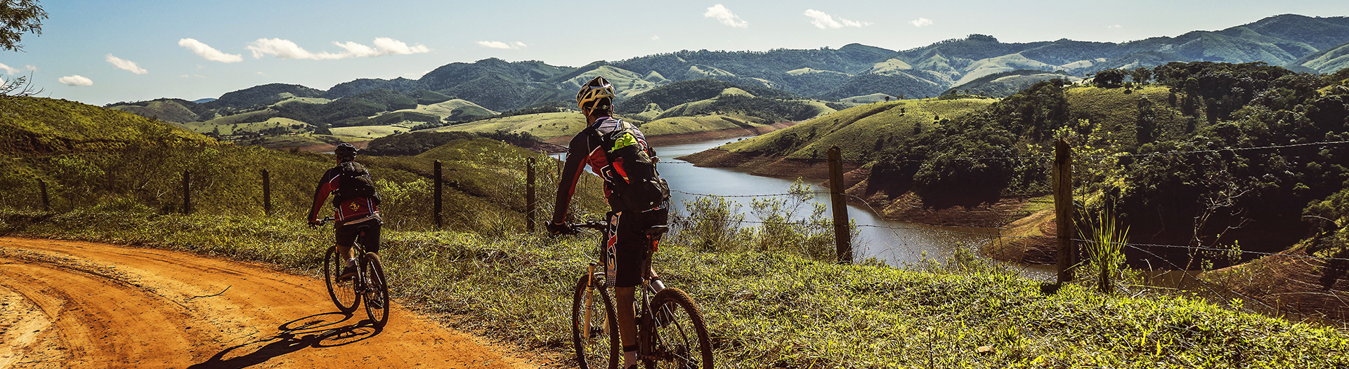 Two men's cycling on mud road
