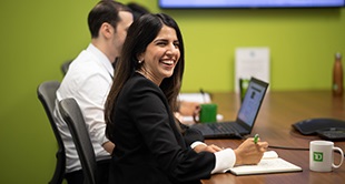 Woman at conference table laughing