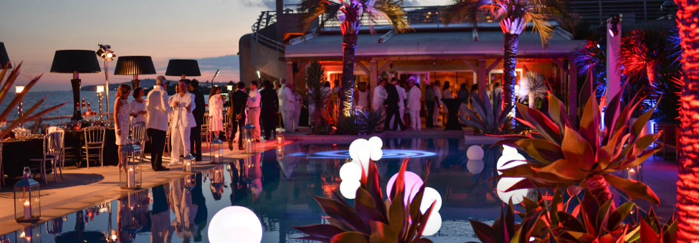 people socializing outside at tropical resort
