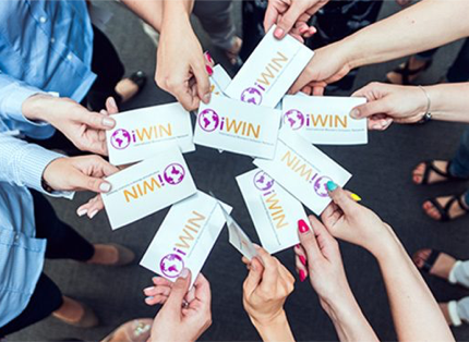 a circle of hands holding iWIN cards