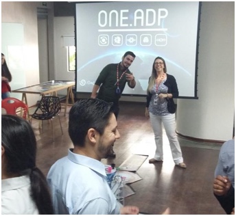 two ADP associates giving a presentation in front of screen