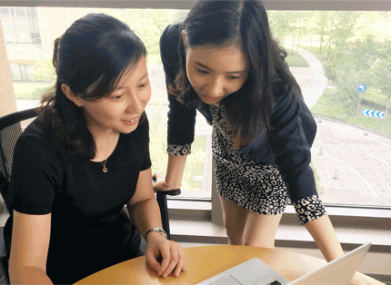two ADP associates looking at a laptop computer