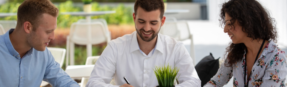 Three people working outside together